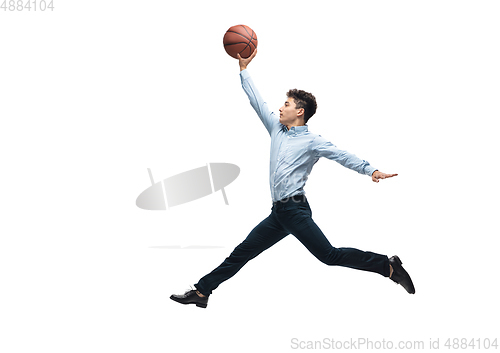 Image of Man in office clothes playing basketball on white background. Unusual look for businessman in motion, action. Sport, healthy lifestyle.