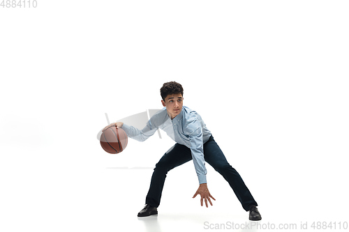 Image of Man in office clothes playing basketball on white background. Unusual look for businessman in motion, action. Sport, healthy lifestyle.