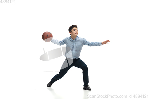 Image of Man in office clothes playing basketball on white background. Unusual look for businessman in motion, action. Sport, healthy lifestyle.