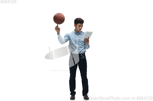 Image of Man in office clothes playing basketball on white background. Unusual look for businessman in motion, action. Sport, healthy lifestyle.