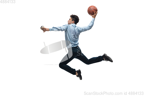 Image of Man in office clothes playing basketball on white background. Unusual look for businessman in motion, action. Sport, healthy lifestyle.