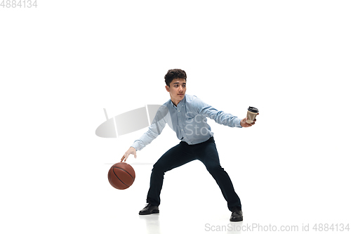 Image of Man in office clothes playing basketball on white background. Unusual look for businessman in motion, action. Sport, healthy lifestyle.