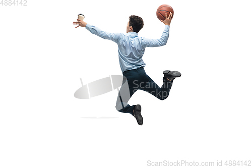 Image of Man in office clothes playing basketball on white background. Unusual look for businessman in motion, action. Sport, healthy lifestyle.