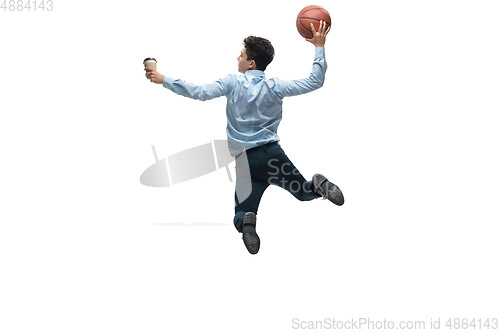 Image of Man in office clothes playing basketball on white background. Unusual look for businessman in motion, action. Sport, healthy lifestyle.