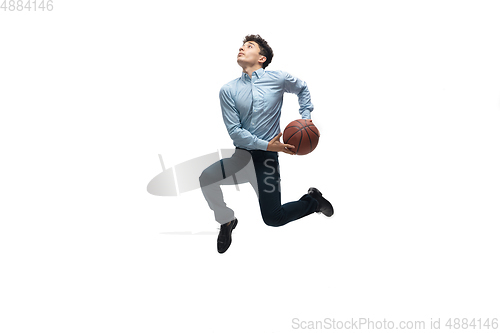 Image of Man in office clothes playing basketball on white background. Unusual look for businessman in motion, action. Sport, healthy lifestyle.