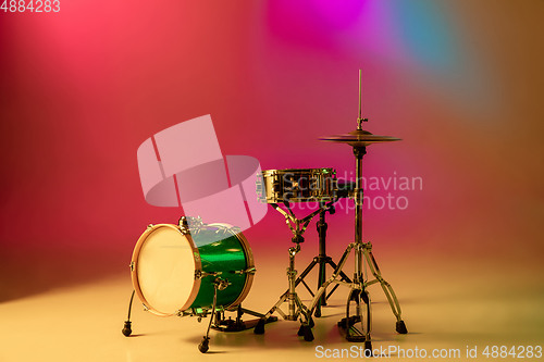 Image of Drum kit or set isolated on multicolored background in neon light