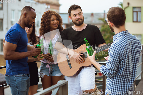 Image of Group of happy friends having beer party in summer day. Resting together outdoor, celebrating and relaxing, laughting. Summer lifestyle, friendship concept.