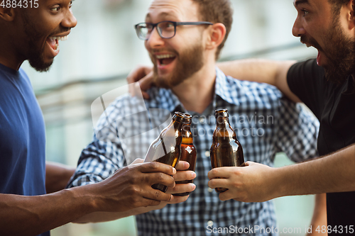 Image of Group of happy friends having beer party in summer day. Resting together outdoor, celebrating and relaxing, laughting. Summer lifestyle, friendship concept.