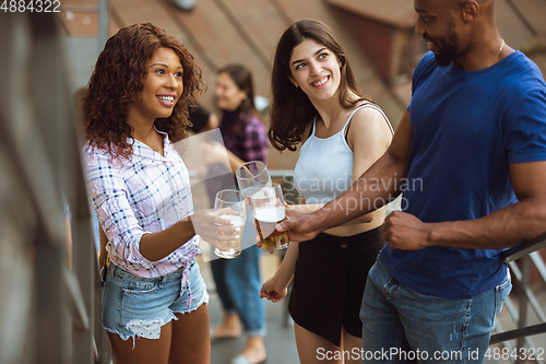 Image of Group of happy friends having beer party in summer day. Resting together outdoor, celebrating and relaxing, laughting. Summer lifestyle, friendship concept.