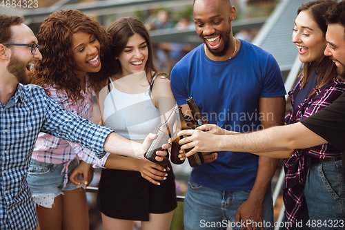 Image of Group of happy friends having beer party in summer day. Resting together outdoor, celebrating and relaxing, laughting. Summer lifestyle, friendship concept.
