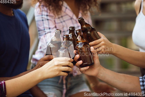 Image of Group of happy friends having beer party in summer day. Resting together outdoor, celebrating and relaxing, laughting. Summer lifestyle, friendship concept.