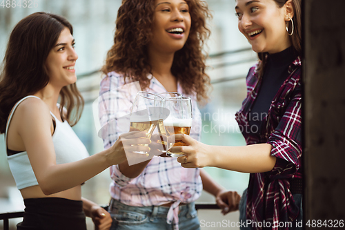 Image of Group of happy friends having beer party in summer day. Resting together outdoor, celebrating and relaxing, laughting. Summer lifestyle, friendship concept.