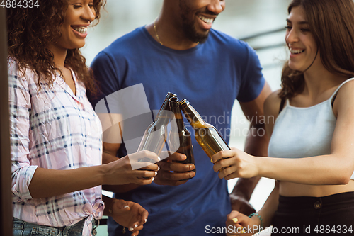 Image of Group of happy friends having beer party in summer day. Resting together outdoor, celebrating and relaxing, laughting. Summer lifestyle, friendship concept.