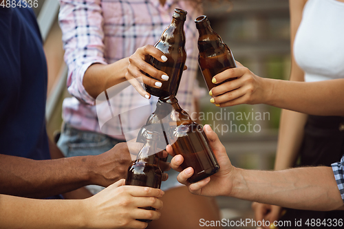 Image of Group of happy friends having beer party in summer day. Resting together outdoor, celebrating and relaxing, laughting. Summer lifestyle, friendship concept.