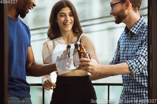 Image of Group of happy friends having beer party in summer day. Resting together outdoor, celebrating and relaxing, laughting. Summer lifestyle, friendship concept.