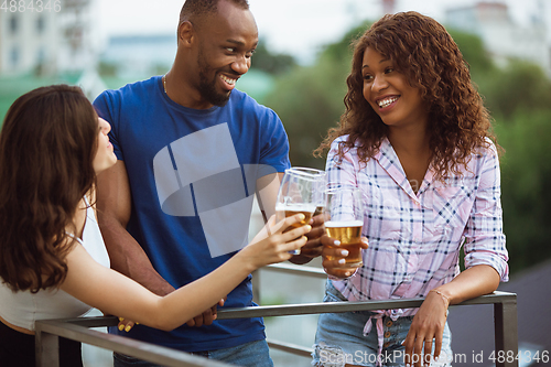 Image of Group of happy friends having beer party in summer day. Resting together outdoor, celebrating and relaxing, laughting. Summer lifestyle, friendship concept.