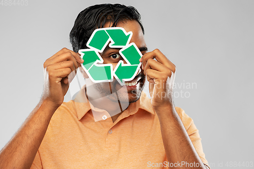 Image of smiling indian man holding green recycling sign