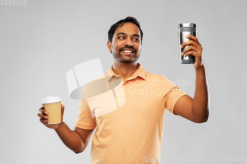 Image of man comparing thermo cup or tumbler and coffee cup