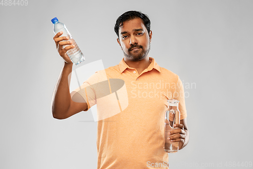 Image of indian man comparing water in different bottles