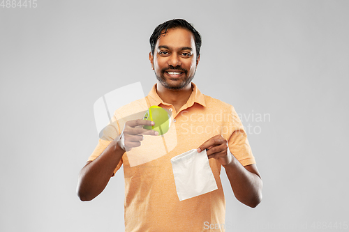 Image of indian man with apple and reusable canvas bag