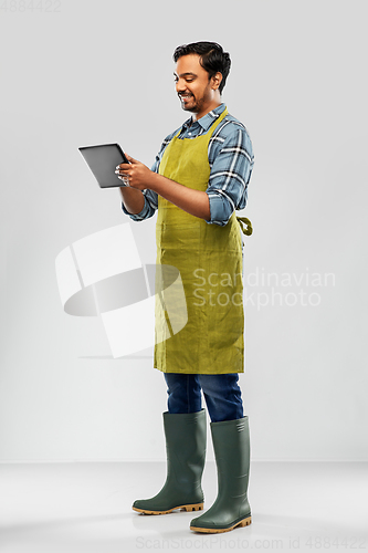 Image of indian male gardener or farmer with tablet pc