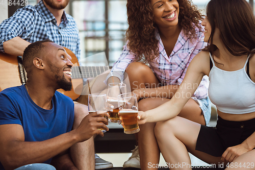 Image of Group of happy friends having beer party in summer day. Resting together outdoor, celebrating and relaxing, laughting. Summer lifestyle, friendship concept.