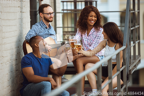 Image of Group of happy friends having beer party in summer day. Resting together outdoor, celebrating and relaxing, laughting. Summer lifestyle, friendship concept.