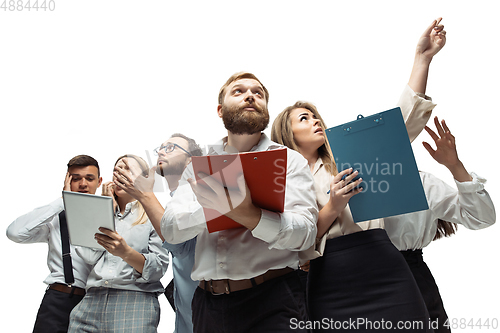 Image of Nervous tensioned investors analyzing crisis stock market with charts on screen of their gadgets