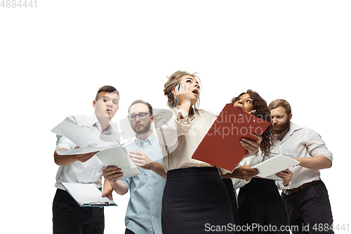 Image of Nervous tensioned investors analyzing crisis stock market with charts on screen of their gadgets