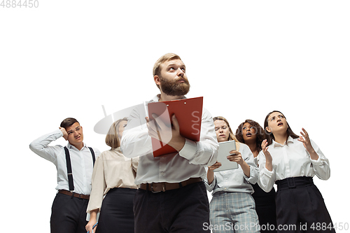 Image of Nervous tensioned investors analyzing crisis stock market with charts on screen of their gadgets