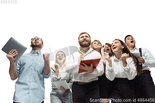 Image of Hopeful and happy investors analyzing crisis stock market with charts on screen of their gadgets