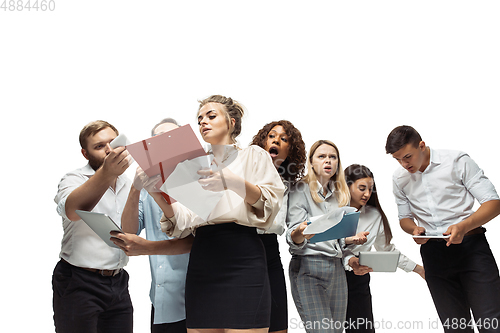 Image of Nervous tensioned investors analyzing crisis stock market with charts on screen of their gadgets