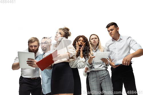 Image of Nervous tensioned investors analyzing crisis stock market with charts on screen of their gadgets