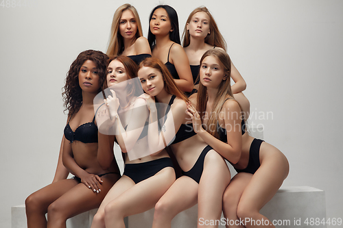 Image of Group of women with different body and ethnicity posing together to show the woman power and strength. Curvy and skinny kind of female body concept