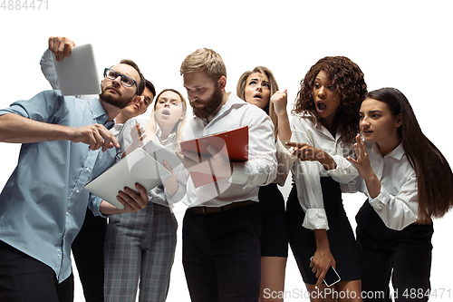 Image of Nervous tensioned investors analyzing crisis stock market with charts on screen of their gadgets