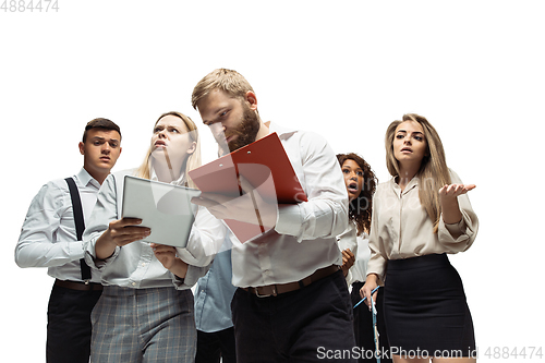 Image of Nervous tensioned investors analyzing crisis stock market with charts on screen of their gadgets