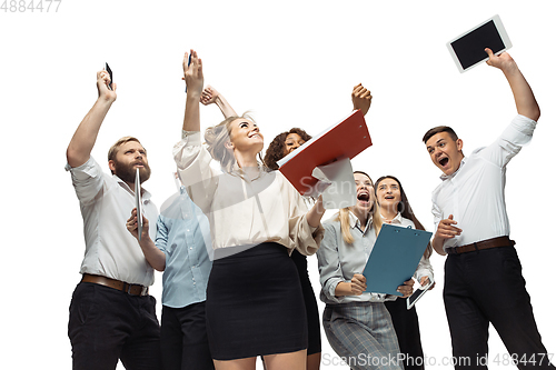 Image of Hopeful and happy investors analyzing crisis stock market with charts on screen of their gadgets