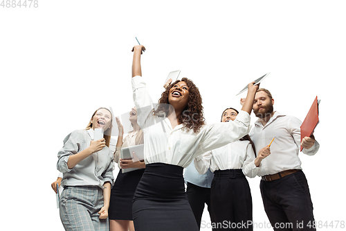 Image of Hopeful and happy investors analyzing crisis stock market with charts on screen of their gadgets