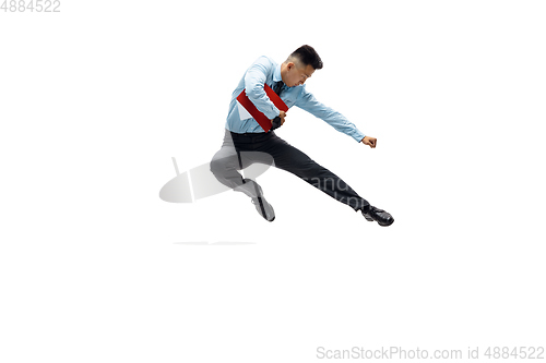 Image of Man in office clothes practicing taekwondo on white background. Unusual look for businessman in motion, action. Sport, healthy lifestyle.