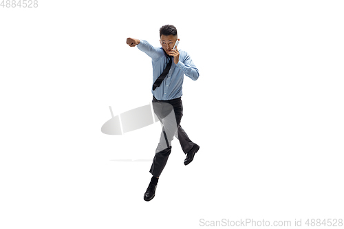 Image of Man in office clothes practicing taekwondo on white background. Unusual look for businessman in motion, action. Sport, healthy lifestyle.