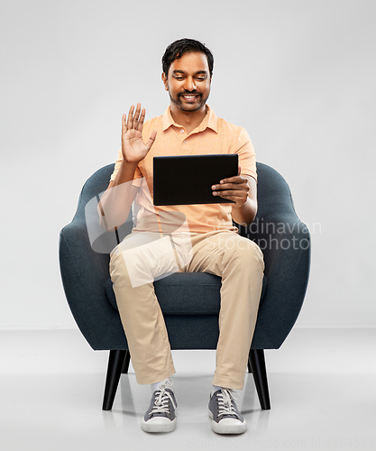 Image of indian man with tablet pc having video call