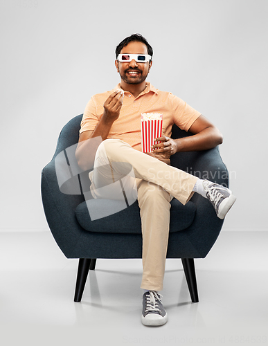 Image of happy man in 3d movie glasses eating popcorn