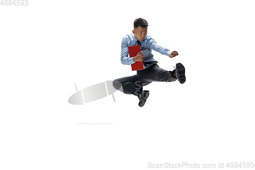 Image of Man in office clothes practicing taekwondo on white background. Unusual look for businessman in motion, action. Sport, healthy lifestyle.