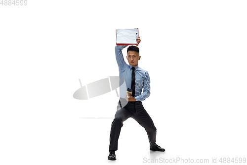 Image of Man in office clothes practicing taekwondo on white background. Unusual look for businessman in motion, action. Sport, healthy lifestyle.