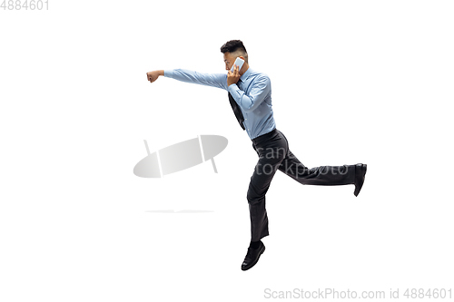 Image of Man in office clothes practicing taekwondo on white background. Unusual look for businessman in motion, action. Sport, healthy lifestyle.