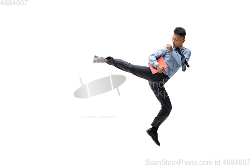 Image of Man in office clothes practicing taekwondo on white background. Unusual look for businessman in motion, action. Sport, healthy lifestyle.
