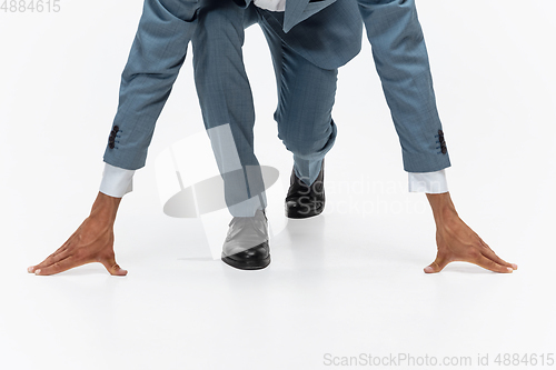 Image of Man in office clothes running, jogging on white background. Unusual look for businessman in motion, action. Sport, healthy lifestyle.