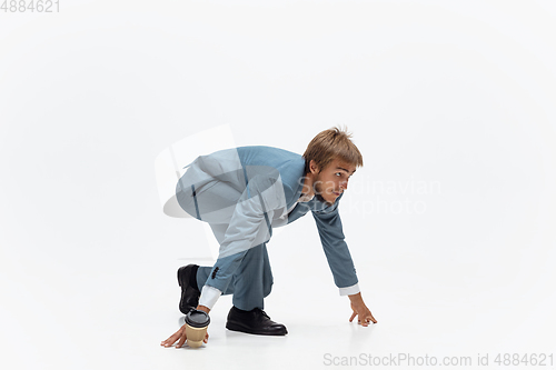 Image of Man in office clothes running, jogging on white background. Unusual look for businessman in motion, action. Sport, healthy lifestyle.