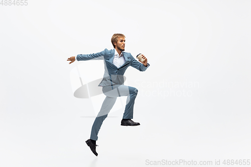 Image of Man in office clothes running, jogging on white background. Unusual look for businessman in motion, action. Sport, healthy lifestyle.
