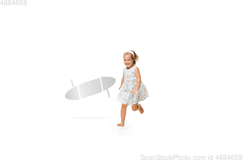 Image of Happy little caucasian girl jumping and running isolated on white background